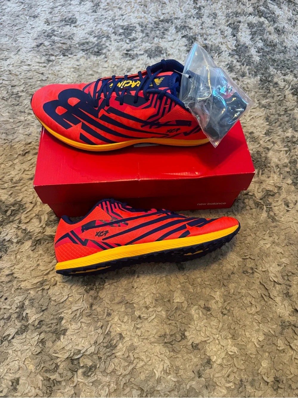 New Balance Red Navy Yellow XC7 running shoes with spikes